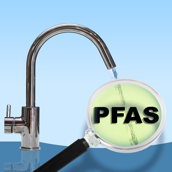 A faucet pours water, magnified by a lens displaying the acronym "PFAS," highlighting water contamination concerns.